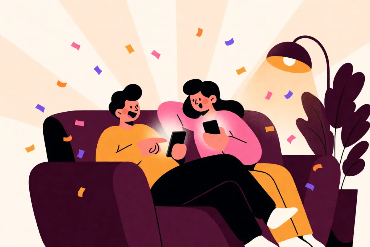 A couple on a sofa laughing at their phones