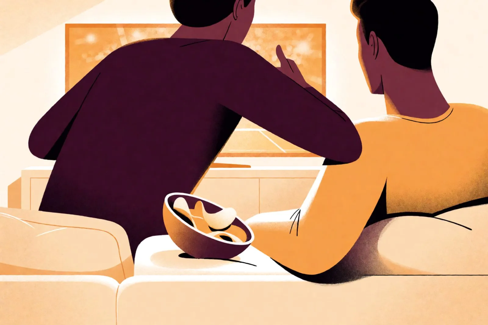 Two hands reaching into the same bowl on a sofa in the orange glow of a screen, two blankets and no faces in the frame.