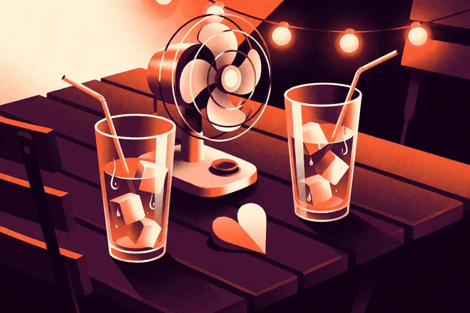 Un ventilador de mesa, dos vasos con bebida helada y un corazón de papel sobre una mesa de patio en una noche cálida, con luz naranja suave.